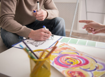 Appealing male hands sketching during session Healing Through Art & Creative Expression